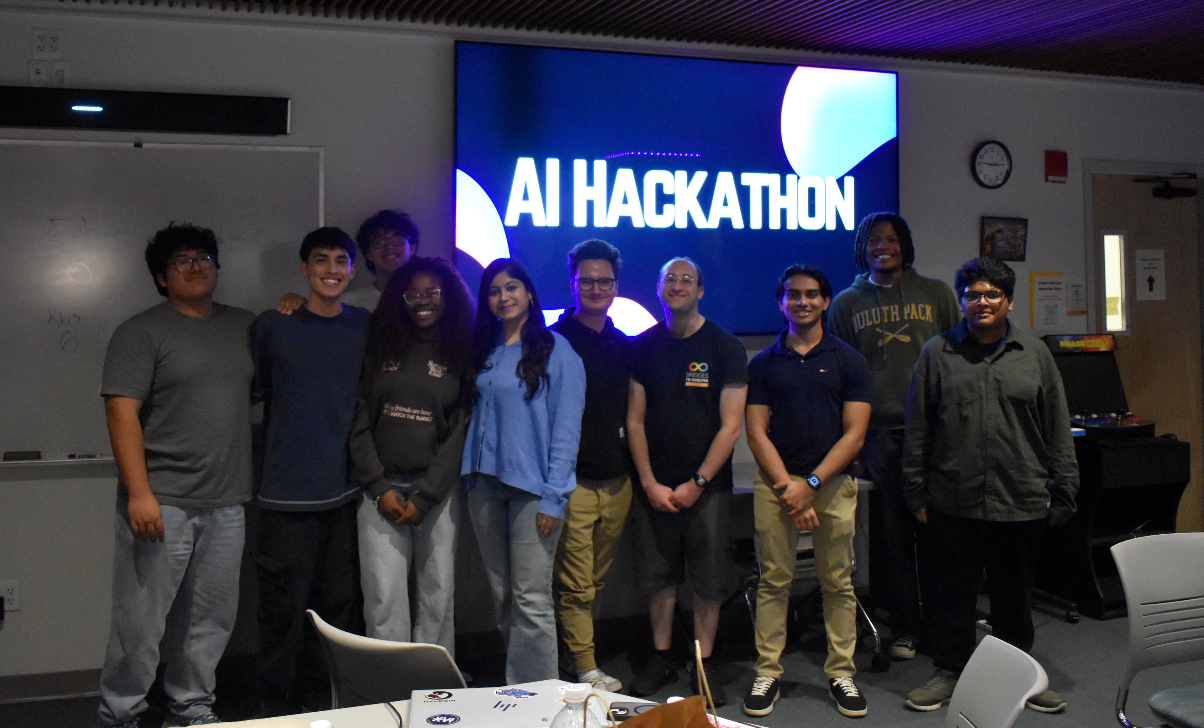 Santiago Rodriguez and Adelphi AI Society members at a community event